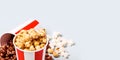 Assorted popcorn set in paper striped white red cup. Royalty Free Stock Photo