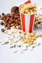 Assorted popcorn set in paper striped white red cup. Sweet and salty popcorn Royalty Free Stock Photo