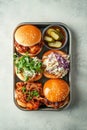 Assorted pulled pork sliders topped with fresh coleslaw and accompanied by pickles present an inviting BBQ feast on a Royalty Free Stock Photo