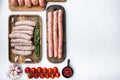 Assorted raw homemade sausages, flat lay with space for text, on white background Royalty Free Stock Photo