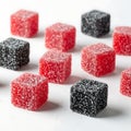 Assorted red and black gummy cubes displayed on a flat surface Royalty Free Stock Photo