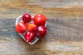 Assorted red chili peppers and spicy mini stacked in a plate heart top view Royalty Free Stock Photo