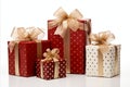 assorted red and white gift wrapped presents with red and gold ribbon bows on white background Royalty Free Stock Photo