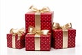 assorted red and white gift wrapped presents with red and gold ribbon bows on white background Royalty Free Stock Photo