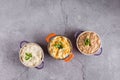 Assorted risottos on gray background. Cheese risotto, mushroom risotto and saffron risotto. Risotto festival Royalty Free Stock Photo