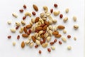 Assorted roasted and raw nuts scattered on white Royalty Free Stock Photo