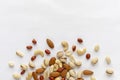 Assorted roasted and raw nuts scattered on white Royalty Free Stock Photo