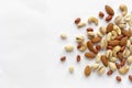 Assorted roasted and raw nuts scattered on white Royalty Free Stock Photo