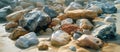 Assorted Rocks on Sandy Beach Royalty Free Stock Photo