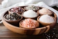 Seven bowls with different types of salts and peppers. Royalty Free Stock Photo