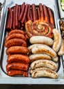 Assorted sausages grilled in a steel container Royalty Free Stock Photo