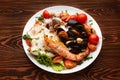 Assorted seafood on a plate on a dark wooden table Royalty Free Stock Photo