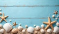Assorted seashells, starfish arranged on rustic blue wooden surface covered with fine sand. Offers bright, clean, airy backdrop Royalty Free Stock Photo
