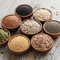 Assorted seeds are displayed in rustic wooden bowls on a wooden surface Royalty Free Stock Photo