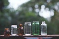 Assorted series collection of empty transparent glass bottle container in white, green and brown color, container reuse concept Royalty Free Stock Photo