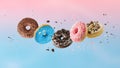 Assorted set colorful glazed donuts with mixed sprinkles and crumbs flying isolated on gradient background Royalty Free Stock Photo