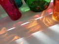 Orange, red, and green bottle reflections in the sunlight Royalty Free Stock Photo