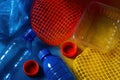 Assorted single use plastic bottles, caps, netting, and packaging arranged on a colored surface illustrating environmental impact Royalty Free Stock Photo