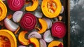 Assorted sliced vegetables on a baking tray ready for roasting