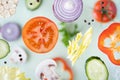 Assorted sliced vegetables levitating above green background