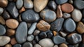 Assorted smooth stones in shades of black, gray, and brown, intricately arranged in a flat layout