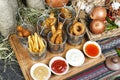 Assorted snacks on the company in the oriental style - onion rings, sausages on skewers Royalty Free Stock Photo