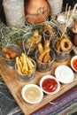 Assorted snacks on the company in the oriental style - onion rings, sausages on skewers Royalty Free Stock Photo