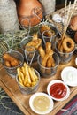 Assorted snacks on the company in the oriental style - onion rings, sausages on skewers Royalty Free Stock Photo