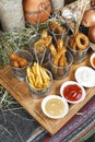 Assorted snacks on the company in the oriental style - onion rings, sausages on skewers Royalty Free Stock Photo