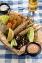 Assorted snacks like deep fried fish, mozzarella sticks, rye bread crouton and glass of beer on the table Royalty Free Stock Photo