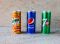 Assorted soft drinks can with 7up, pepsi and mirinda isolated on background top view cold drinks