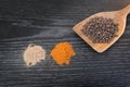 Assorted spices and condiments on table black wooden Royalty Free Stock Photo