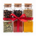 Assorted Spices in Glass Bottles with Red Ribbon on White Background Royalty Free Stock Photo