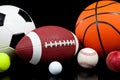 Assorted sports balls on a black background Royalty Free Stock Photo