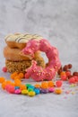 Assorted stack donuts and strawberry biting donuts lay in front