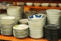 Assorted Stacks of Ceramic Plates on a Wooden Shelf Royalty Free Stock Photo