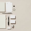 Assorted stationery items arranged on a beige surface include blank Royalty Free Stock Photo