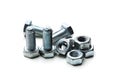 Assorted steel bolts and nuts arranged on a clean surface for mechanical assembly Royalty Free Stock Photo