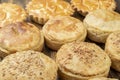 Assorted stuffed homemade pies over wooden table