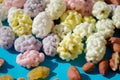 Assorted of sugared dried fruits, nuts and dragees in sugar, on blue background