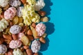 Assorted of sugared dried fruits, nuts and dragees in sugar, on blue background with copyspace