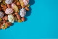 Assorted of sugared dried fruits, nuts and dragees in sugar, on blue background with copyspace