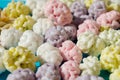 Assorted of sugared nuts and dragees in sugar in shape of cloud, on blue background