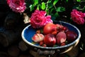 Assorted summer fruits and roses