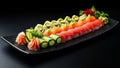 Assorted sushi elegantly arranged on a sleek rectangular black plate.