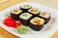 Assorted sushi with ginger and wasabi on bamboo mat close up. Royalty Free Stock Photo