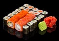 Assorted Sushi maki set with ginger and wasabi isolated on black background with reflection Royalty Free Stock Photo