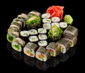 Assorted Sushi maki set with ginger and wasabi isolated on black background with reflection Royalty Free Stock Photo