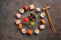 Assorted sushi roll, soy sauce, wasabi and ginger on a dark background. Japanese sushi set, round frame. Top view, flat lay Royalty Free Stock Photo