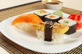 Assorted sushi and rolls and soy sauce on bamboo mat close up. Royalty Free Stock Photo